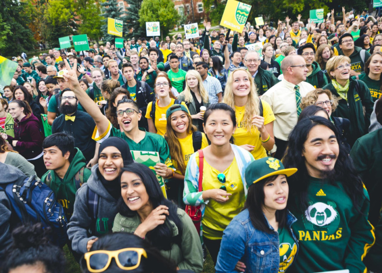 Students gathered wearing green and gold colours