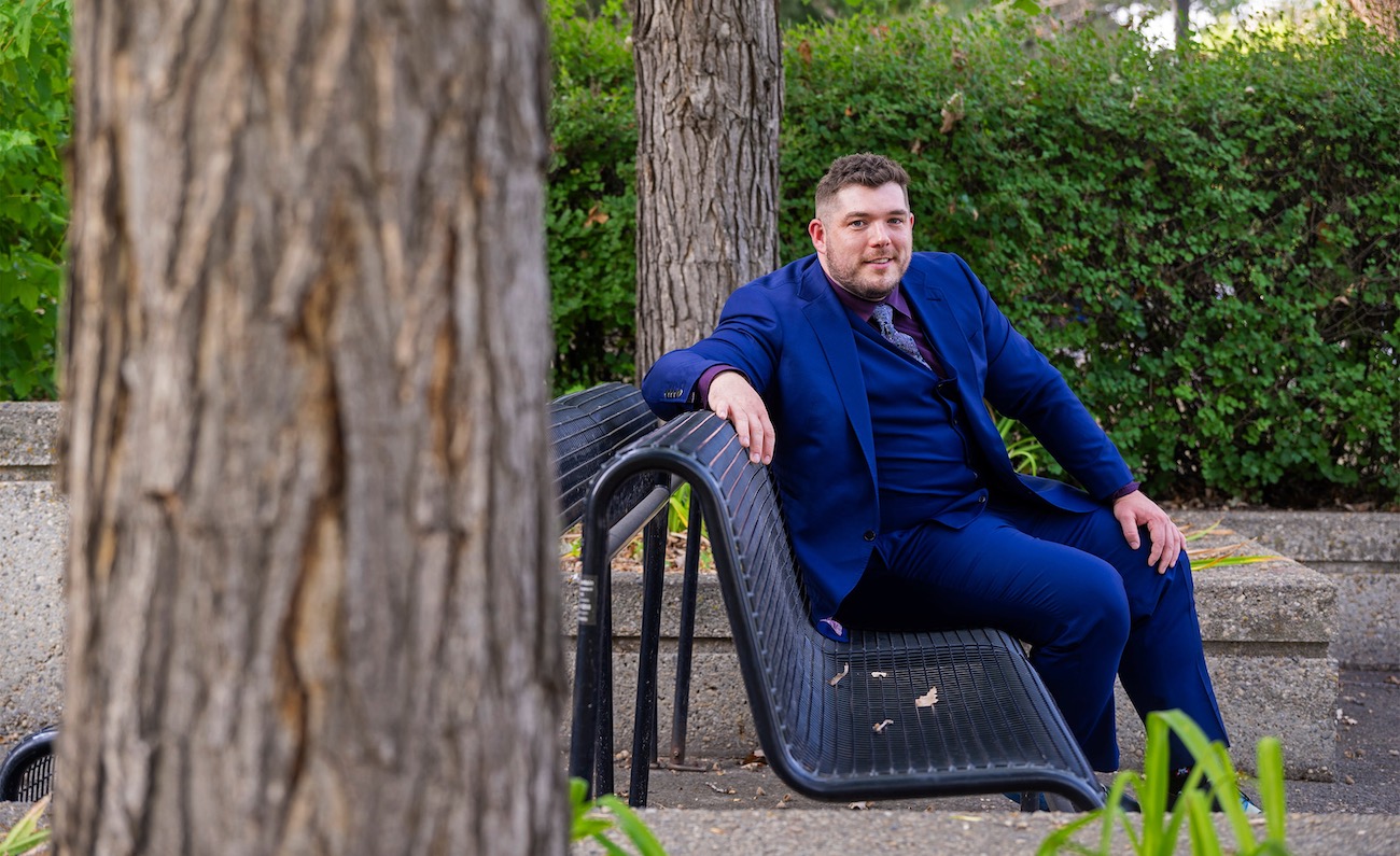 Dustin Edwards on a bench on campus