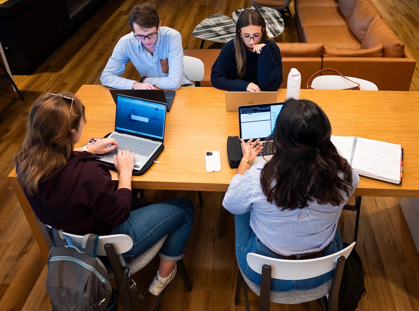 Emma Tucker, Patrick Battigelli, Helena Rizzuto and Maria Kalapurayil prepare for a moot at a library table