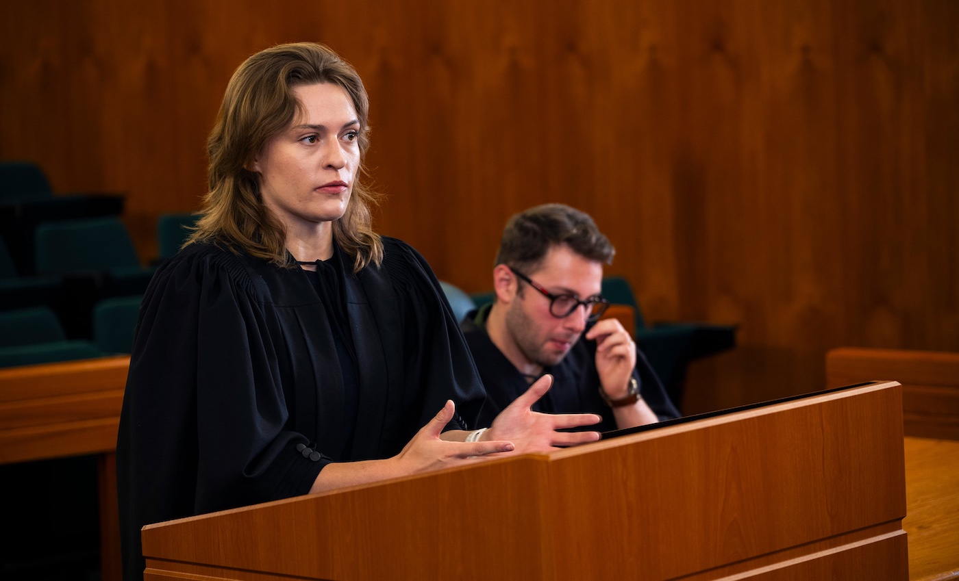Emma Tucker speaking in a moot and Alborz Azizpourshoobi sitting beside her