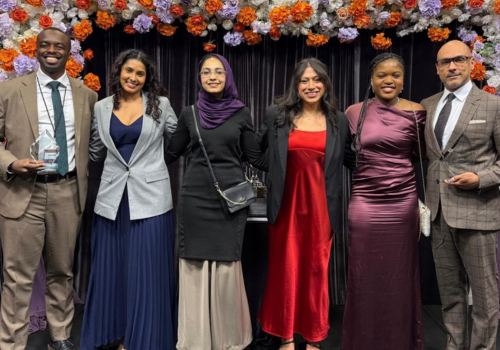 The four team members for the Isaac Moot poses with their coaches