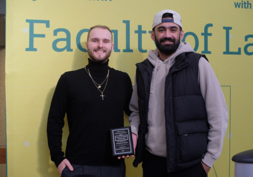 Johnathan Bobinac and Armann Singh pose with a plaque at the Celebration of Mooting