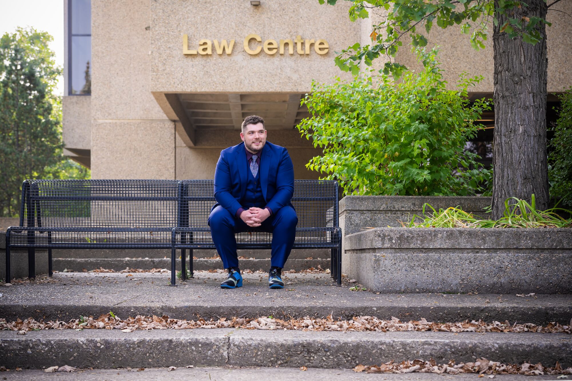 A student sits on the bench outside the Law Centre