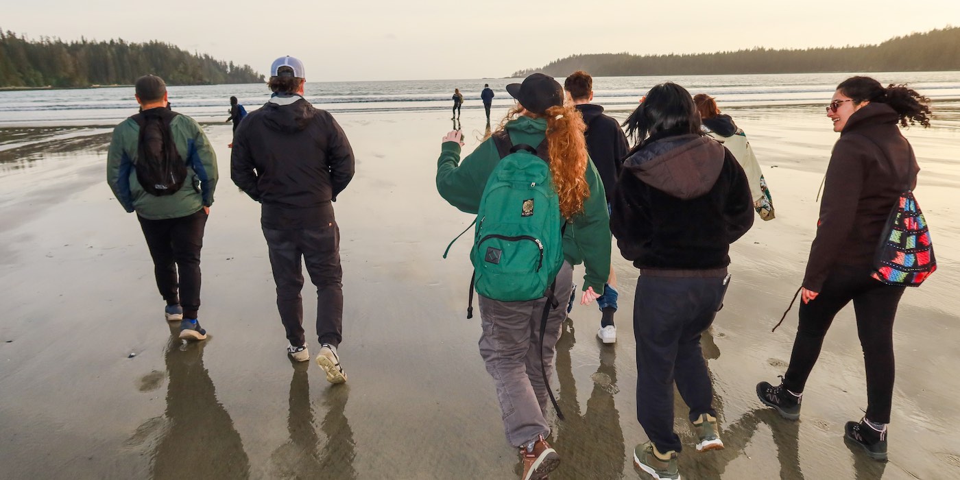 Students walking along a beach