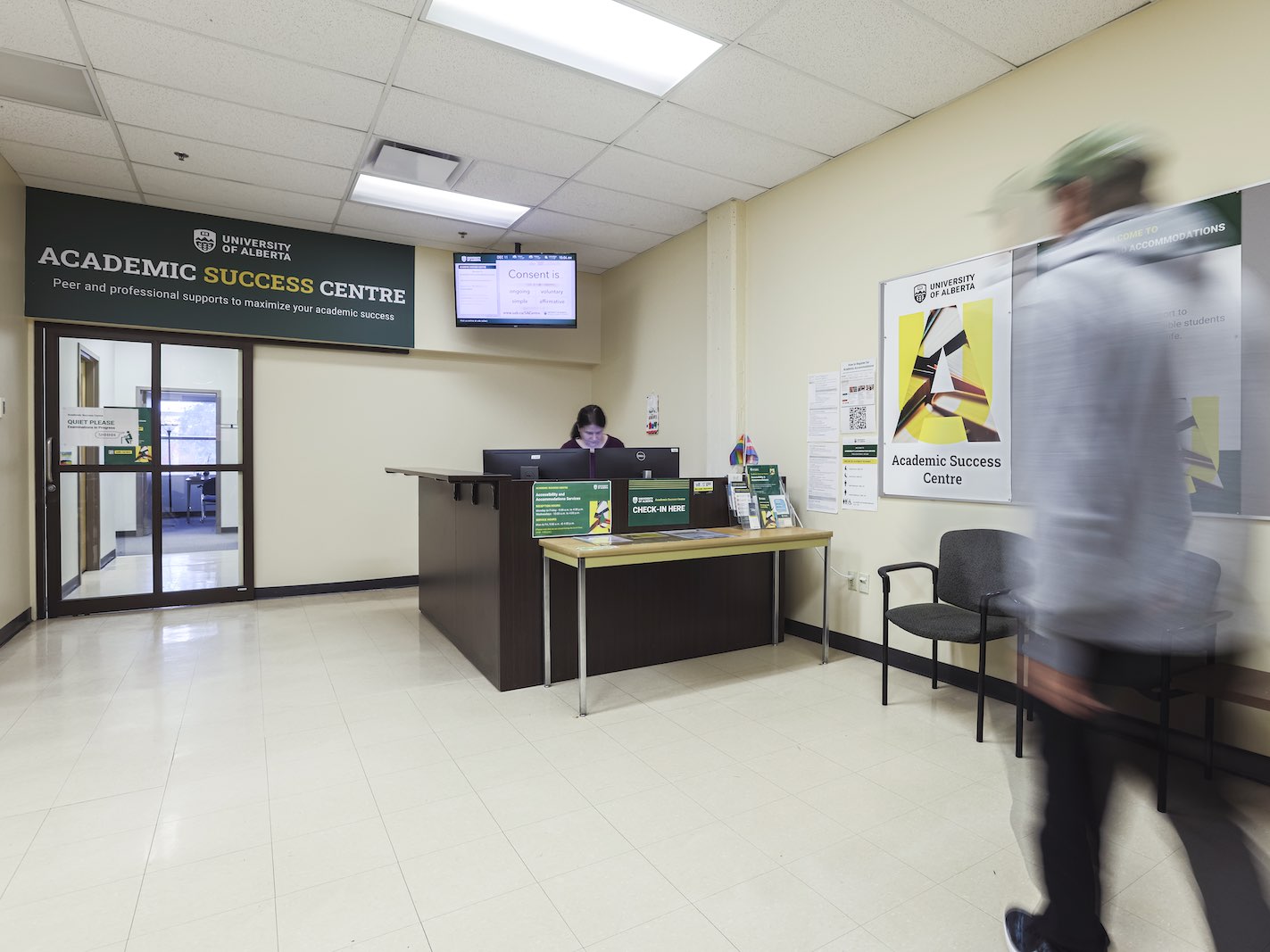Academic Success Centre lobby, with the receptionist behind the desk and a man walking towards her