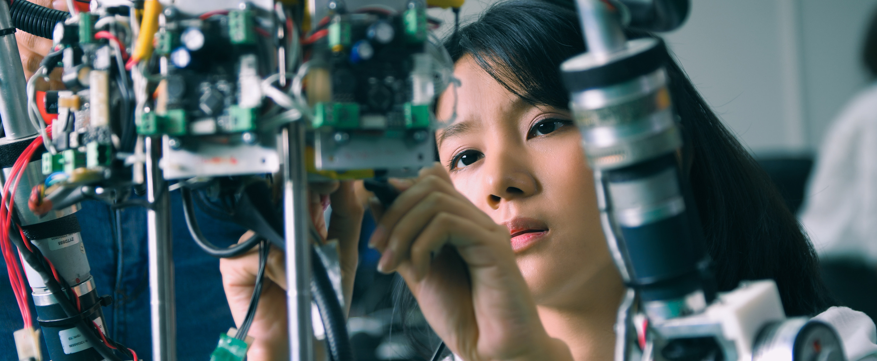 Individual working on machinery in research lab.