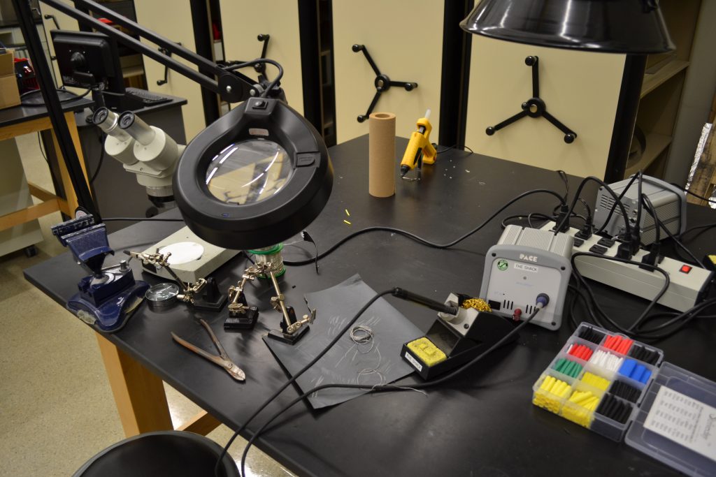 Soldering equipment laid out on a workbench